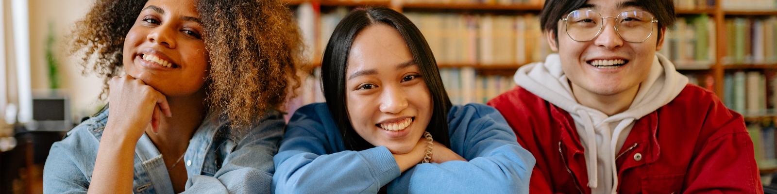 Smiling teens with books
